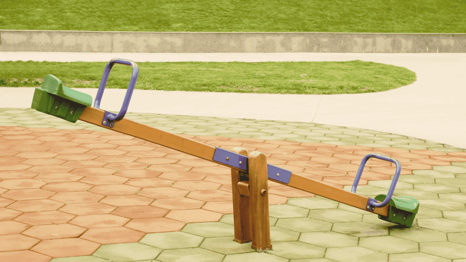 Einfache Wippe im Ungleichgewicht symbolisiert die Nähe Distanz Spirale zwischen ängstlichem und vermeidendem Bindungstyp